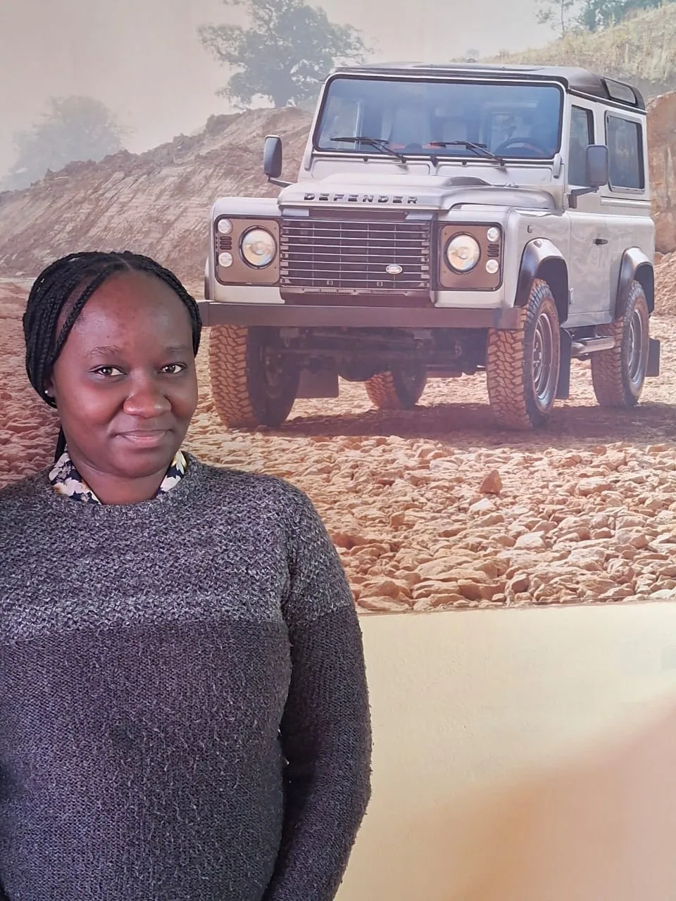 Thivariko Tjirera, Namvic Tours and Safaris accounts and administrative assistant, photographed in front of a 4x4 safari vehicle image